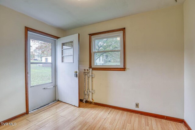 entryway with light wood-type flooring and baseboards
