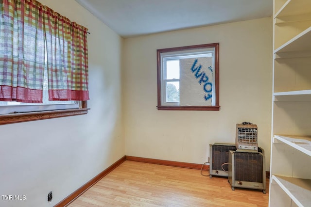 interior space featuring baseboards and wood finished floors