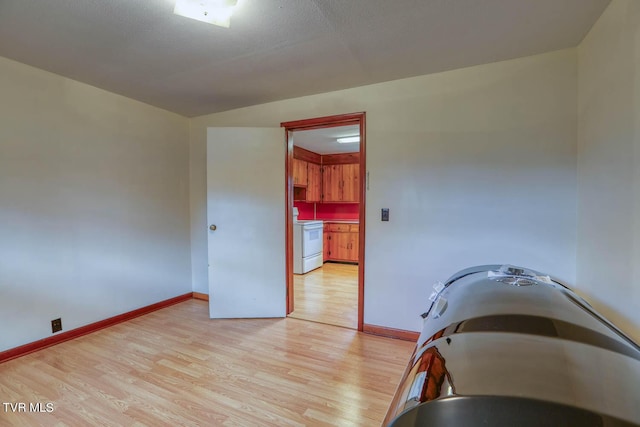 dining area with baseboards and light wood-style flooring