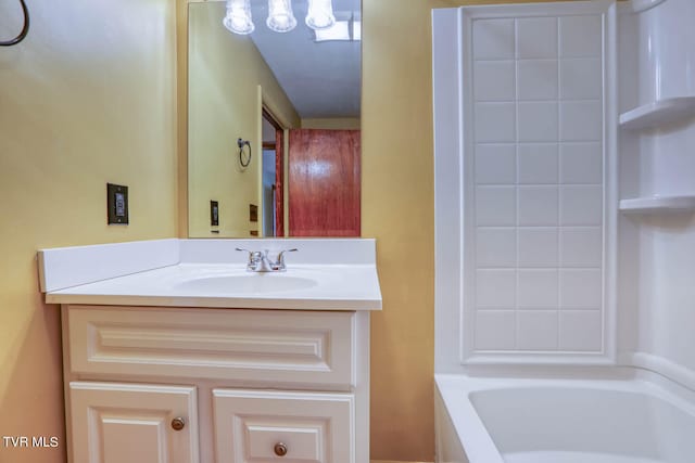 bathroom with vanity and a bath