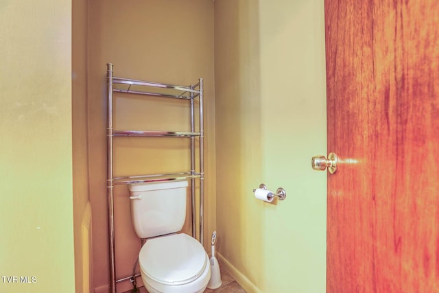 bathroom with baseboards and toilet