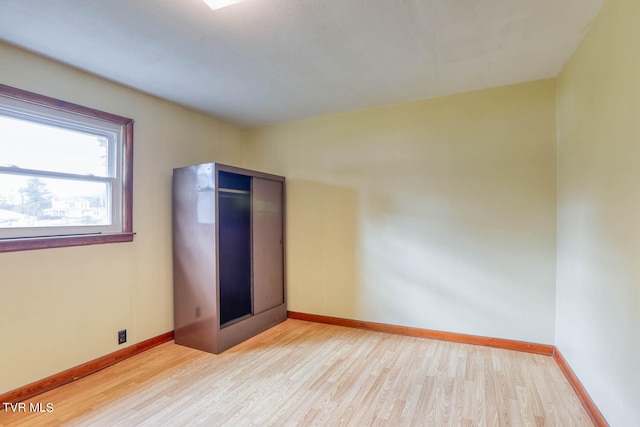 unfurnished bedroom with a closet and light hardwood / wood-style floors