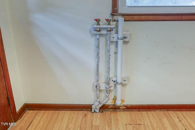 room details featuring baseboards and wood finished floors