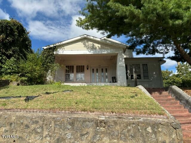 view of front of property with french doors and a front yard