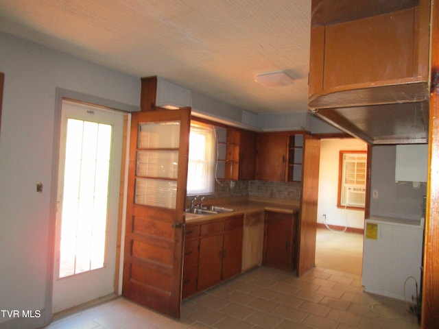 kitchen with cooling unit, decorative backsplash, a healthy amount of sunlight, and sink