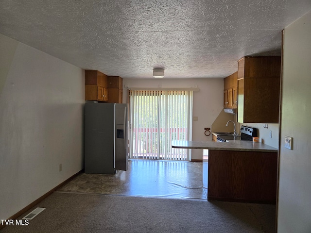 kitchen with sink, a textured ceiling, and stainless steel fridge with ice dispenser