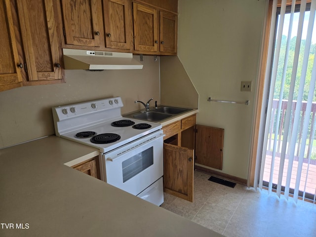 kitchen featuring sink, white electric range, and light tile patterned floors