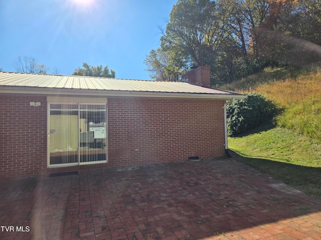 view of side of home with a patio area