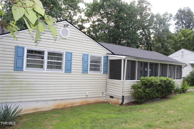 view of home's exterior with a lawn and a sunroom