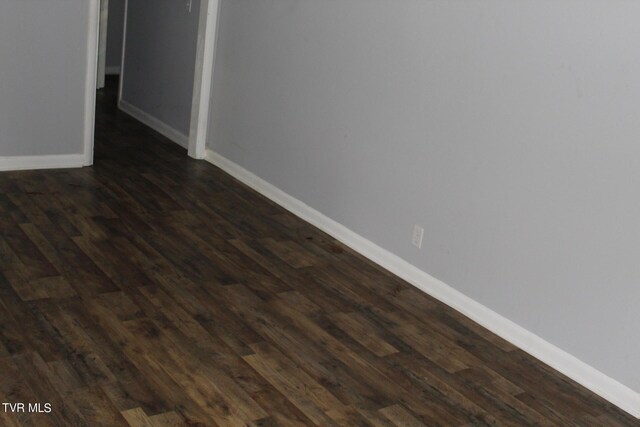 empty room featuring dark wood-type flooring