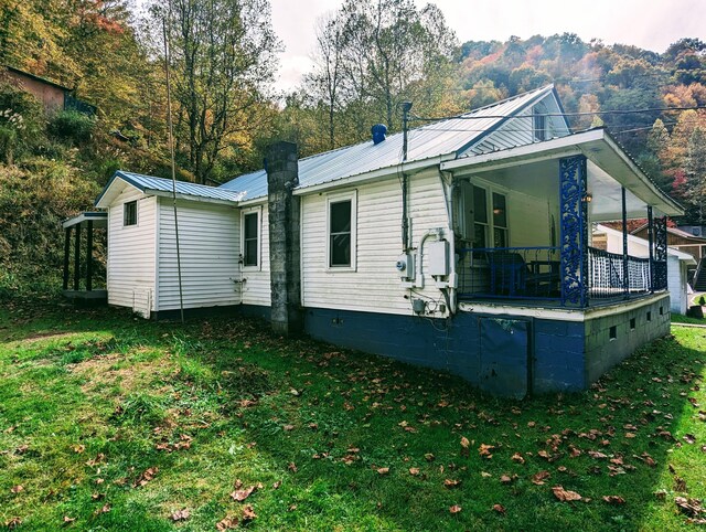 rear view of house with a yard