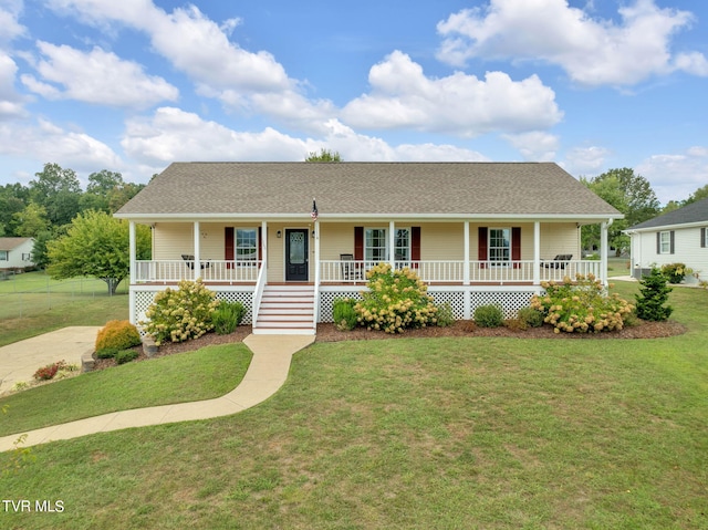 view of front of house with covered porch and a front lawn