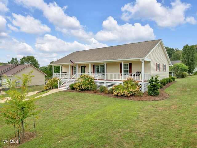 ranch-style house featuring a porch and a front lawn