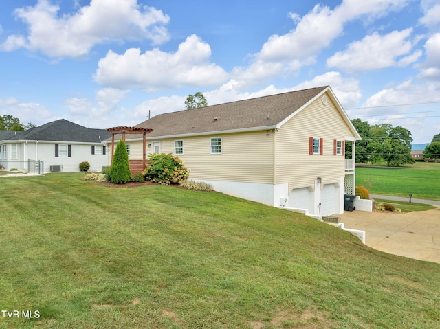 view of side of home featuring a yard, a garage, and a pergola