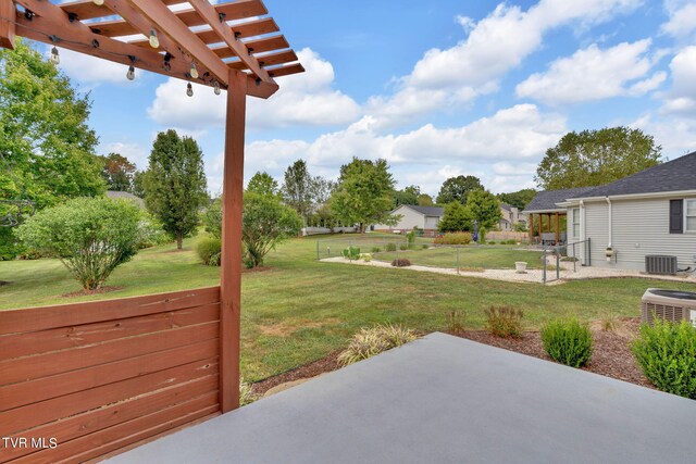 view of yard with a pergola, a patio area, and central AC