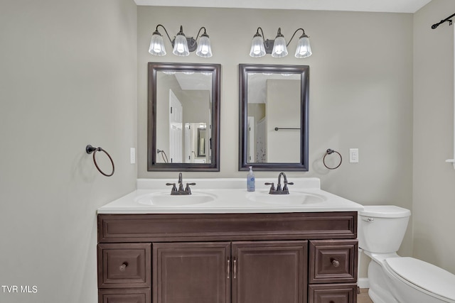 bathroom featuring vanity and toilet