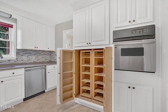 kitchen featuring appliances with stainless steel finishes, white cabinetry, sink, and light tile patterned flooring