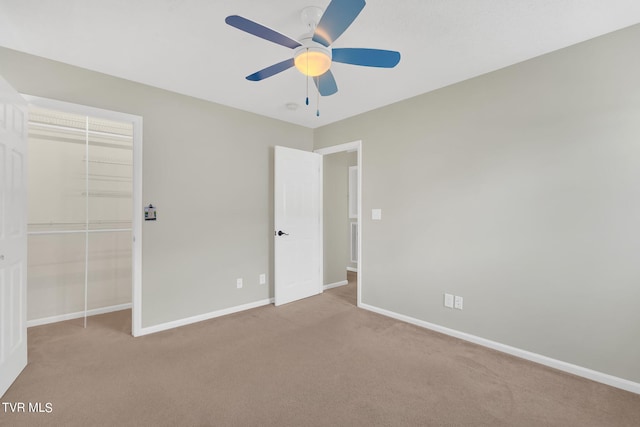 unfurnished bedroom featuring a closet, ceiling fan, and light colored carpet