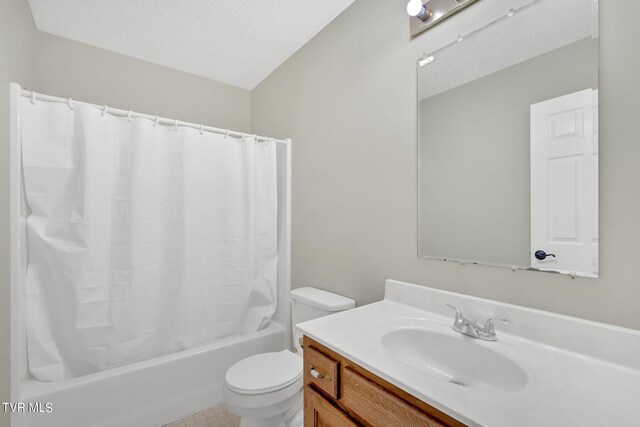 full bathroom featuring vanity, toilet, a textured ceiling, and shower / bath combo