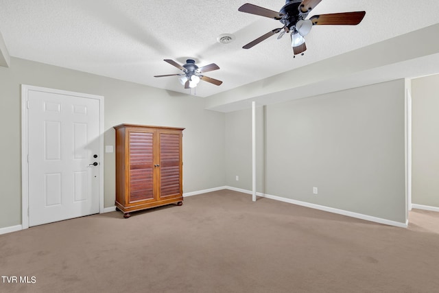 unfurnished room with carpet flooring, ceiling fan, and a textured ceiling