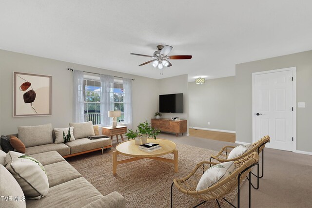 carpeted living room with ceiling fan