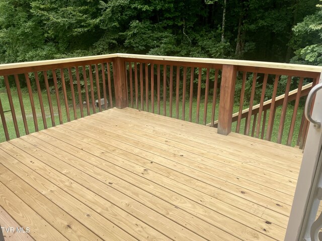 wooden terrace featuring a yard