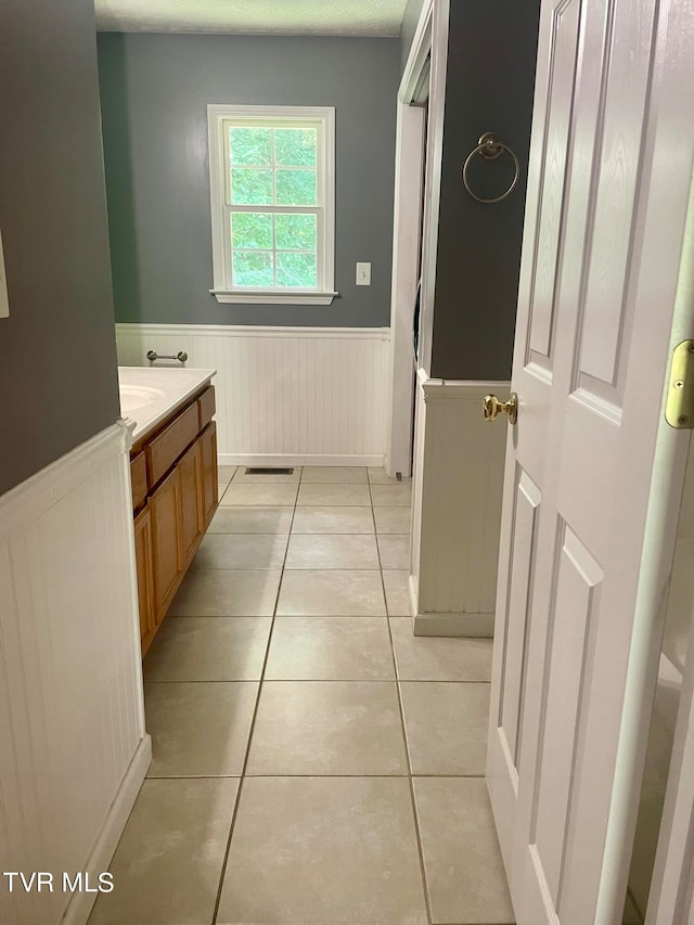 bathroom with tile patterned flooring and a textured ceiling