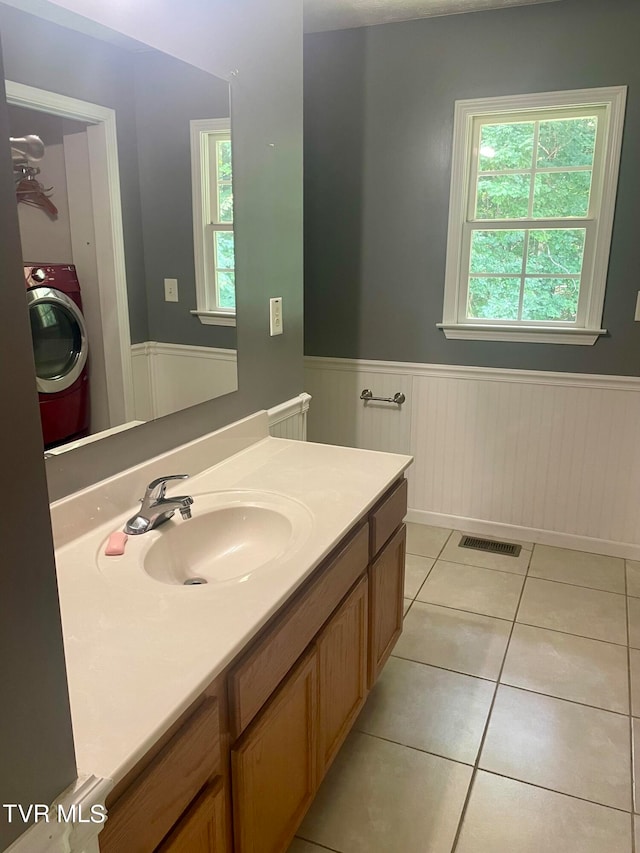 bathroom with vanity, tile patterned flooring, and washer / clothes dryer