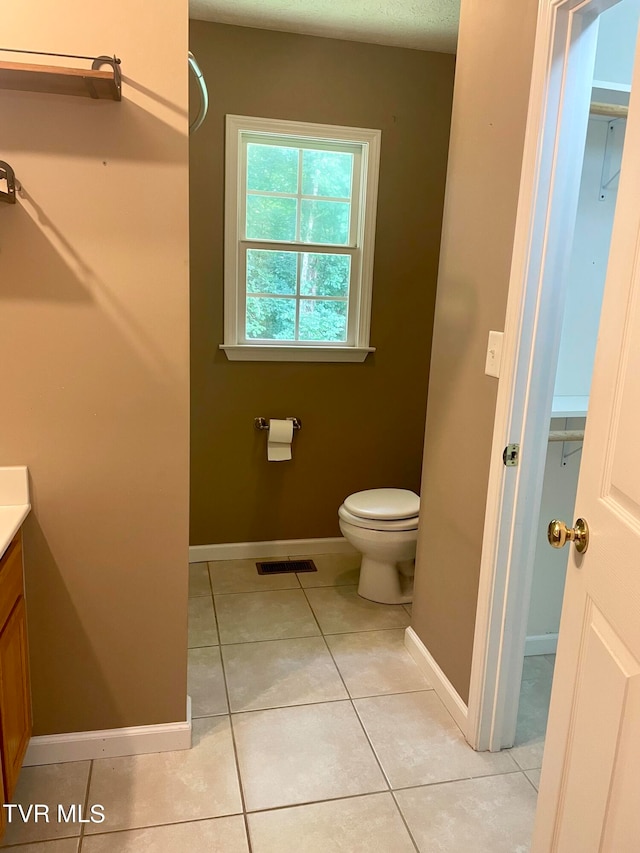 bathroom with vanity, toilet, and tile patterned floors