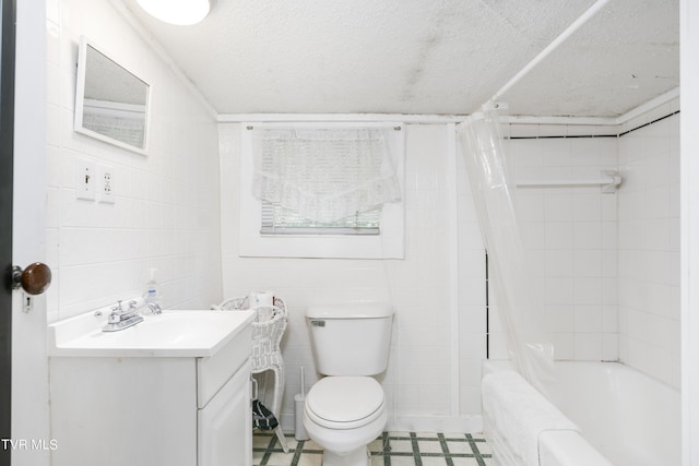 full bathroom featuring a textured ceiling, vanity, shower / bath combo, and toilet