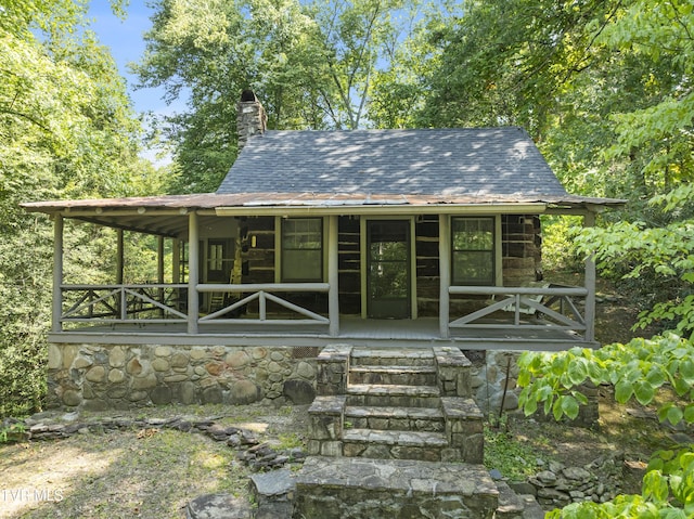 back of property with a porch