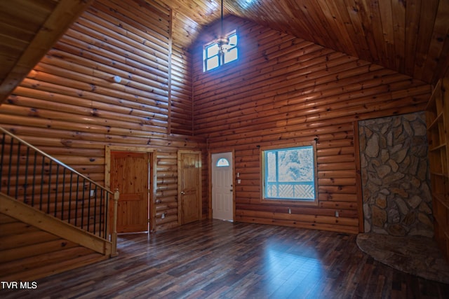 entryway with dark wood-type flooring, rustic walls, high vaulted ceiling, and wooden ceiling