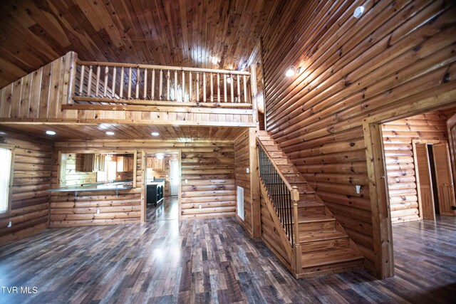 interior space featuring log walls, wood-type flooring, and wooden ceiling