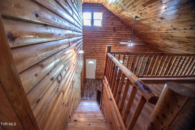 staircase with lofted ceiling, hardwood / wood-style floors, ceiling fan, and wooden ceiling