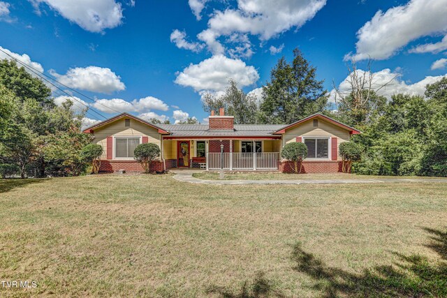 single story home featuring covered porch and a front lawn