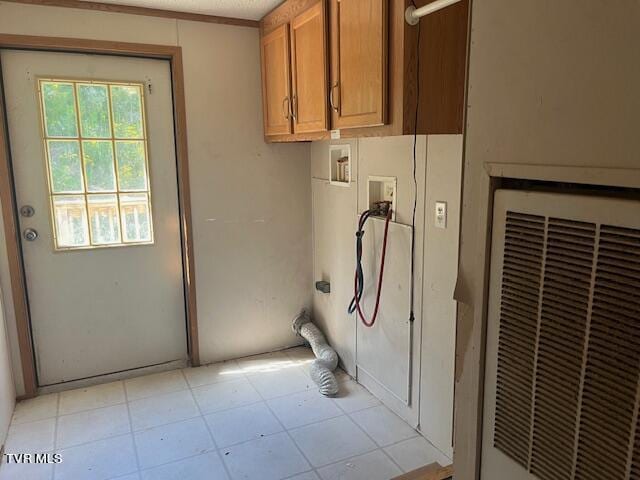 laundry room featuring hookup for a washing machine, cabinet space, and a heating unit