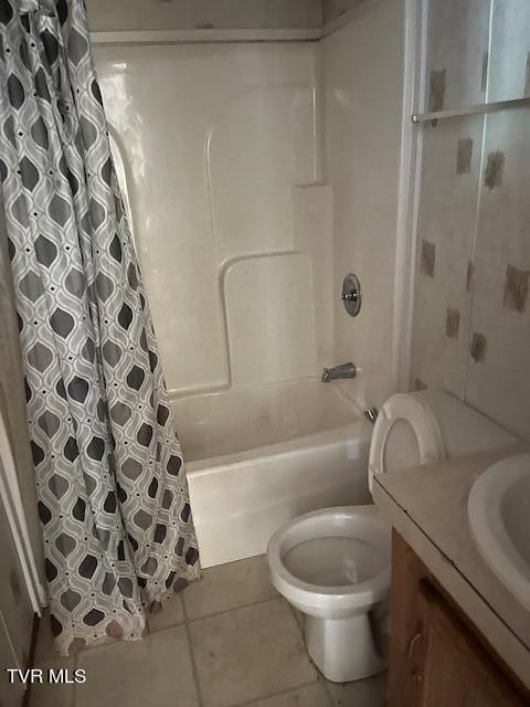 bathroom with tile patterned flooring, vanity, toilet, and shower / tub combo