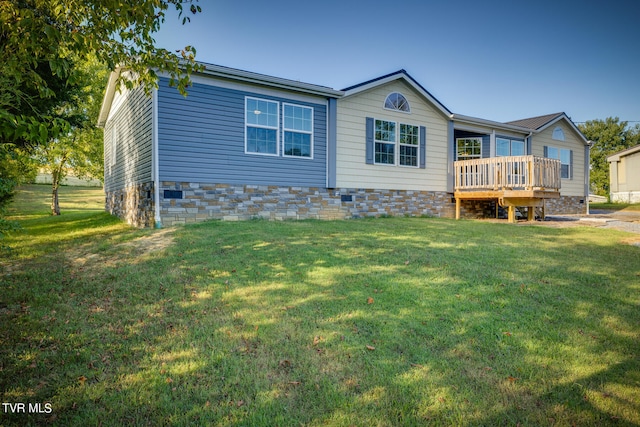 view of front of home with a front yard and a deck