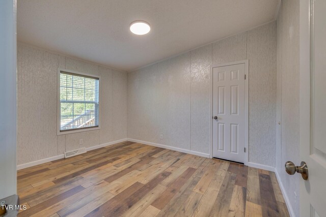 empty room with light hardwood / wood-style flooring