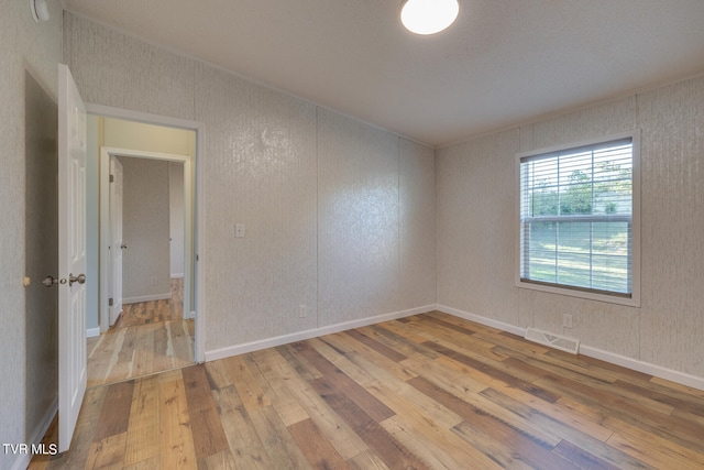 unfurnished room featuring light hardwood / wood-style floors