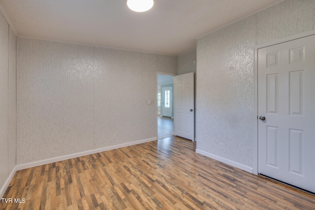 spare room with wood-type flooring