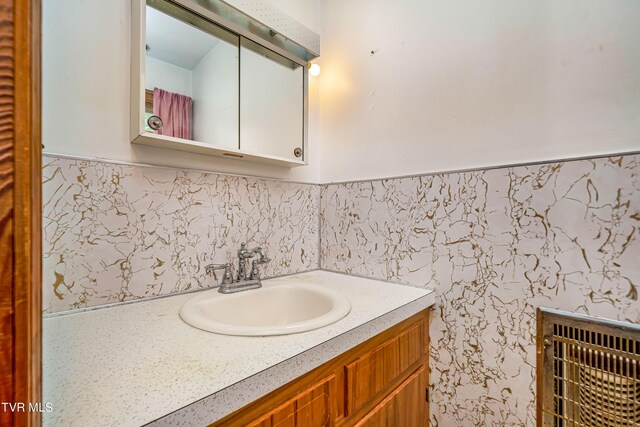 bathroom featuring vanity and heating unit