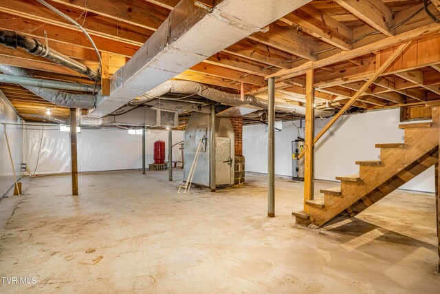 basement featuring heating unit and water heater