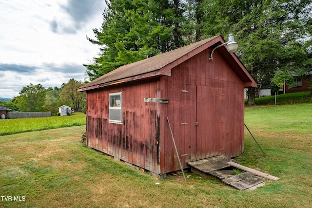 view of outdoor structure featuring a lawn