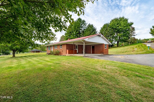 single story home with a carport and a front lawn