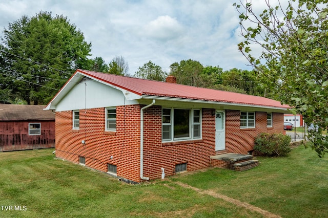 rear view of property with a yard