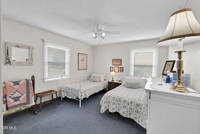 carpeted bedroom with a textured ceiling and ceiling fan