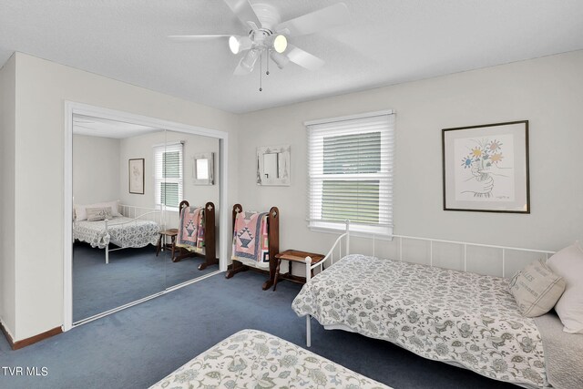 carpeted bedroom with a closet, ceiling fan, and a textured ceiling