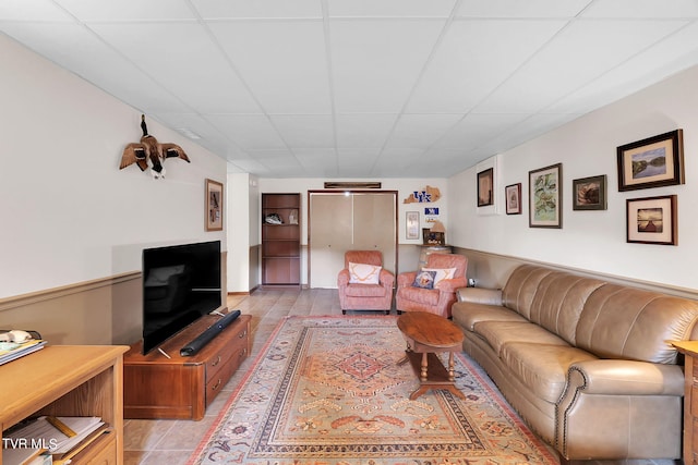 tiled living room with a drop ceiling