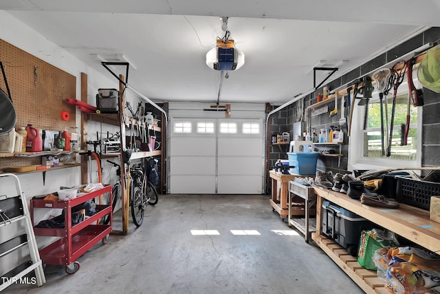 garage with a workshop area and a garage door opener